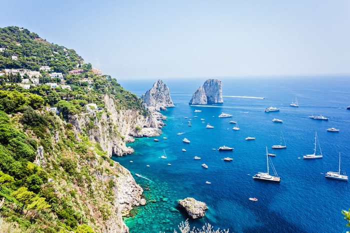 Faraglioni rocks visible from Giardini di Augusto in Capri, Italy. Focus on stone rocks
