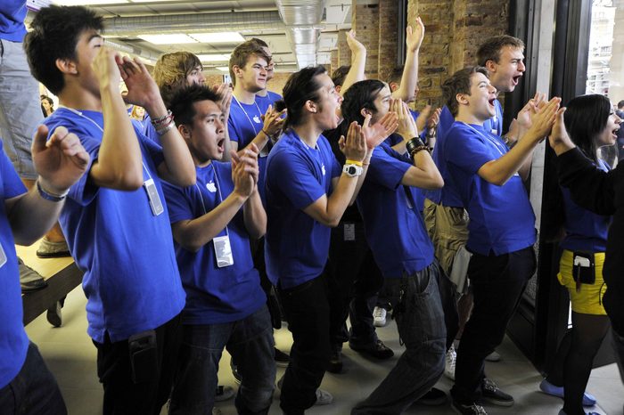 Apple store staff greeting customers