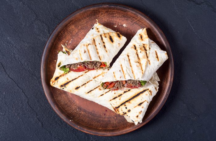 Homemade tasty burrito with vegetables and beef