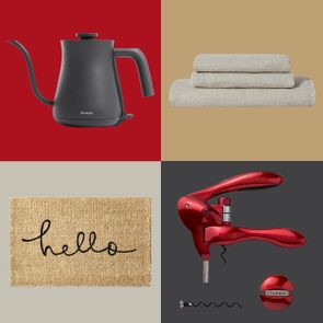 Kettle rests on red, towels stack on beige, mat with 