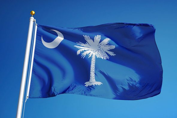 South Carolina (U.S. state) flag waving against clear blue sky, close up, isolated with clipping path mask alpha channel transparency, perfect for film, news, composition