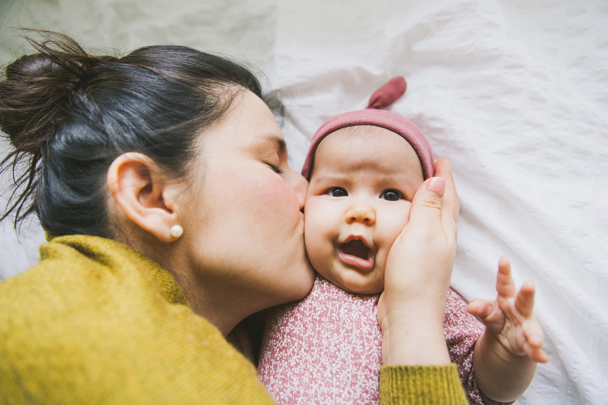 Mother kissing baby girl