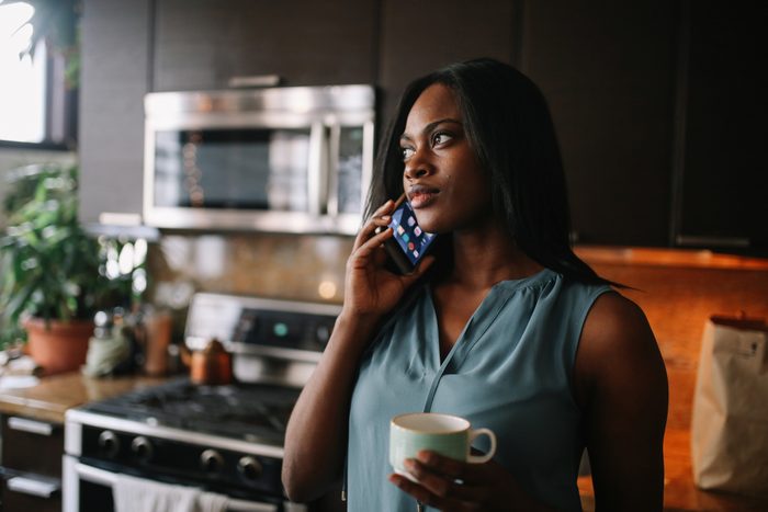 Young woman having a morning coffee in her Downtown Los Angeles apartment