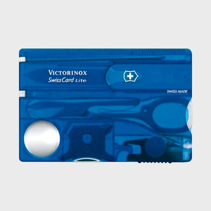 SwissCard Lite is a compact, multifunctional toolset with scissors, light, and magnifying glass, enclosed in a blue translucent credit card-sized case.
