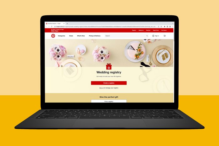 Laptop displays wedding registry webpage featuring a red 