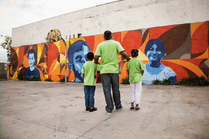 Father and children volunteering together
