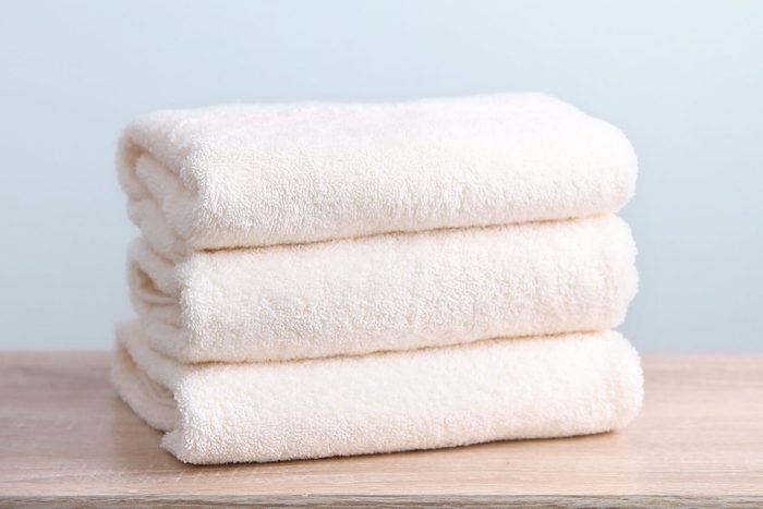Stack of folded towels empty copy space.