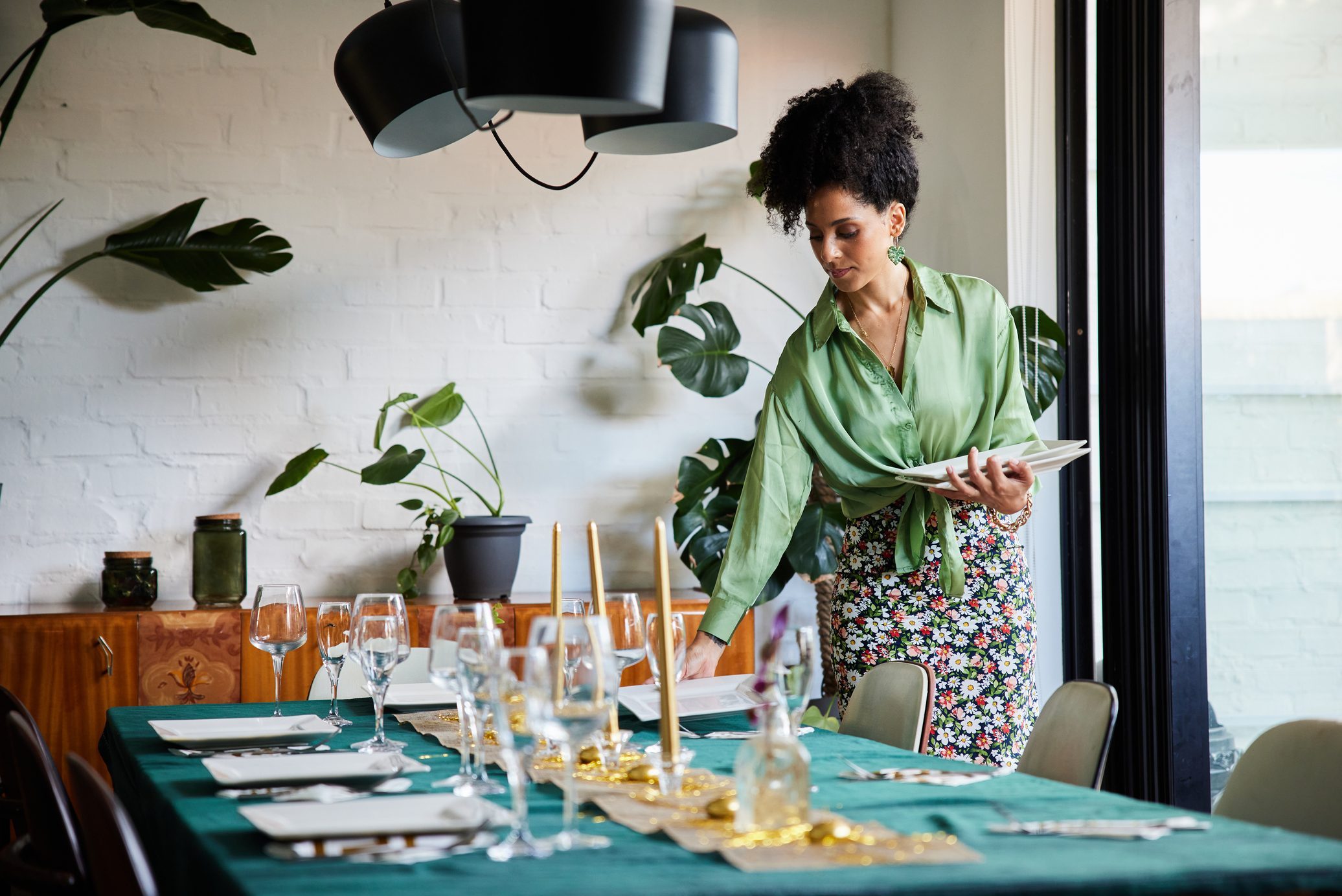 Young woman setting her dining table before a dinner party