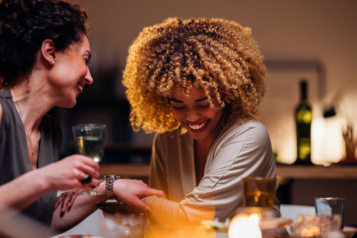 Two Friends Having Fun During A Dinner Party
