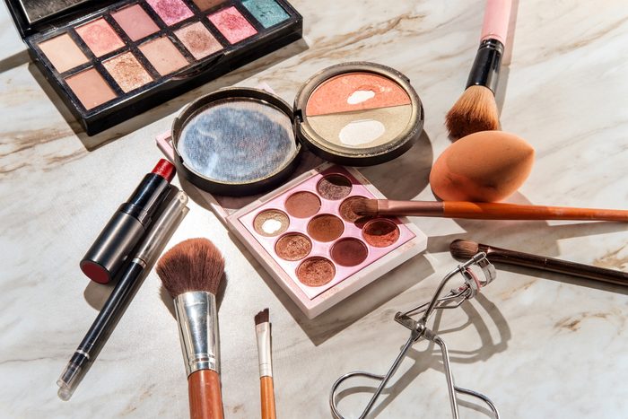 Used beauty cosmetics products on a marble table