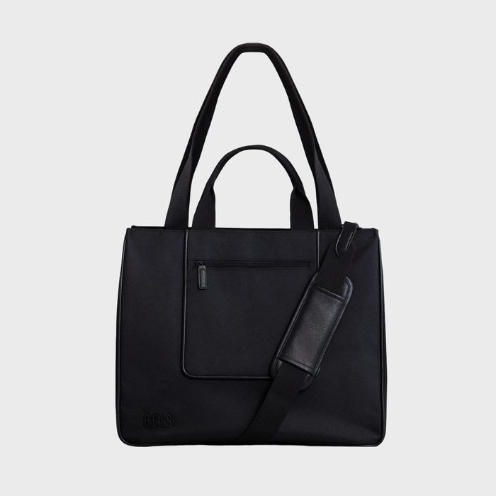 Black bag with handles and shoulder strap displayed against a plain background; includes a front zipper pocket and 
