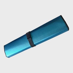 Blue, textured rolled mat secured with a black strap, isolated against a plain background.