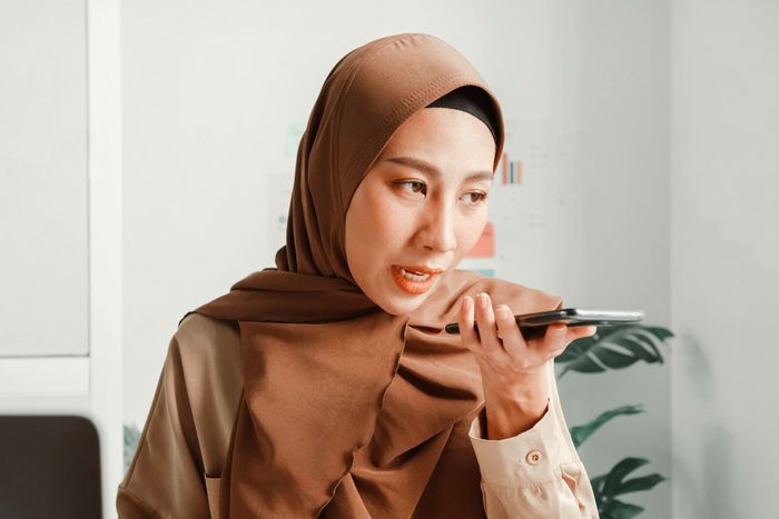 woman talking on speaker phone in the waiting room at the doctors