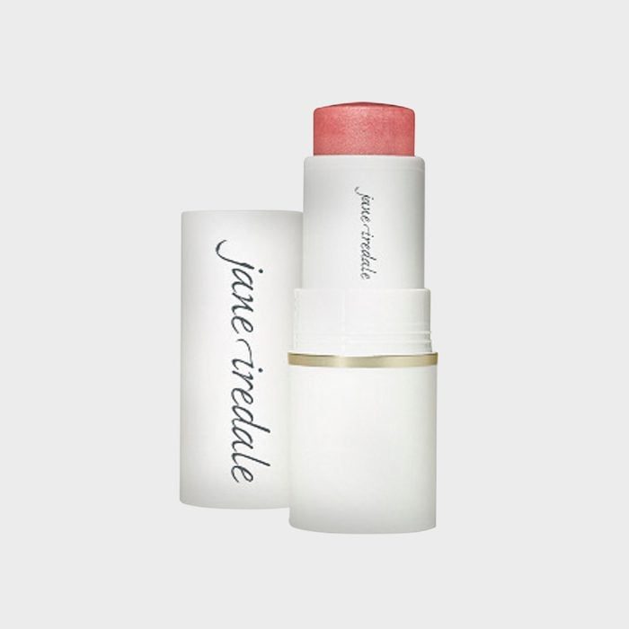 A lipstick tube with pink color exposed, standing upright, next to its cap. Text says 