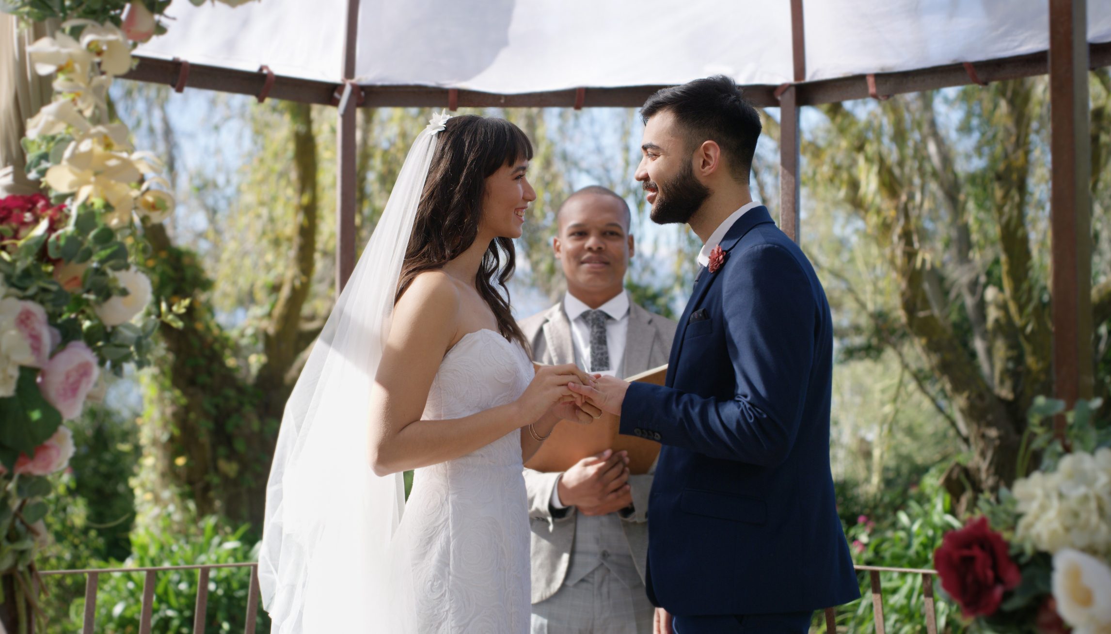 Couple exchanging wedding vows in front of an officiant